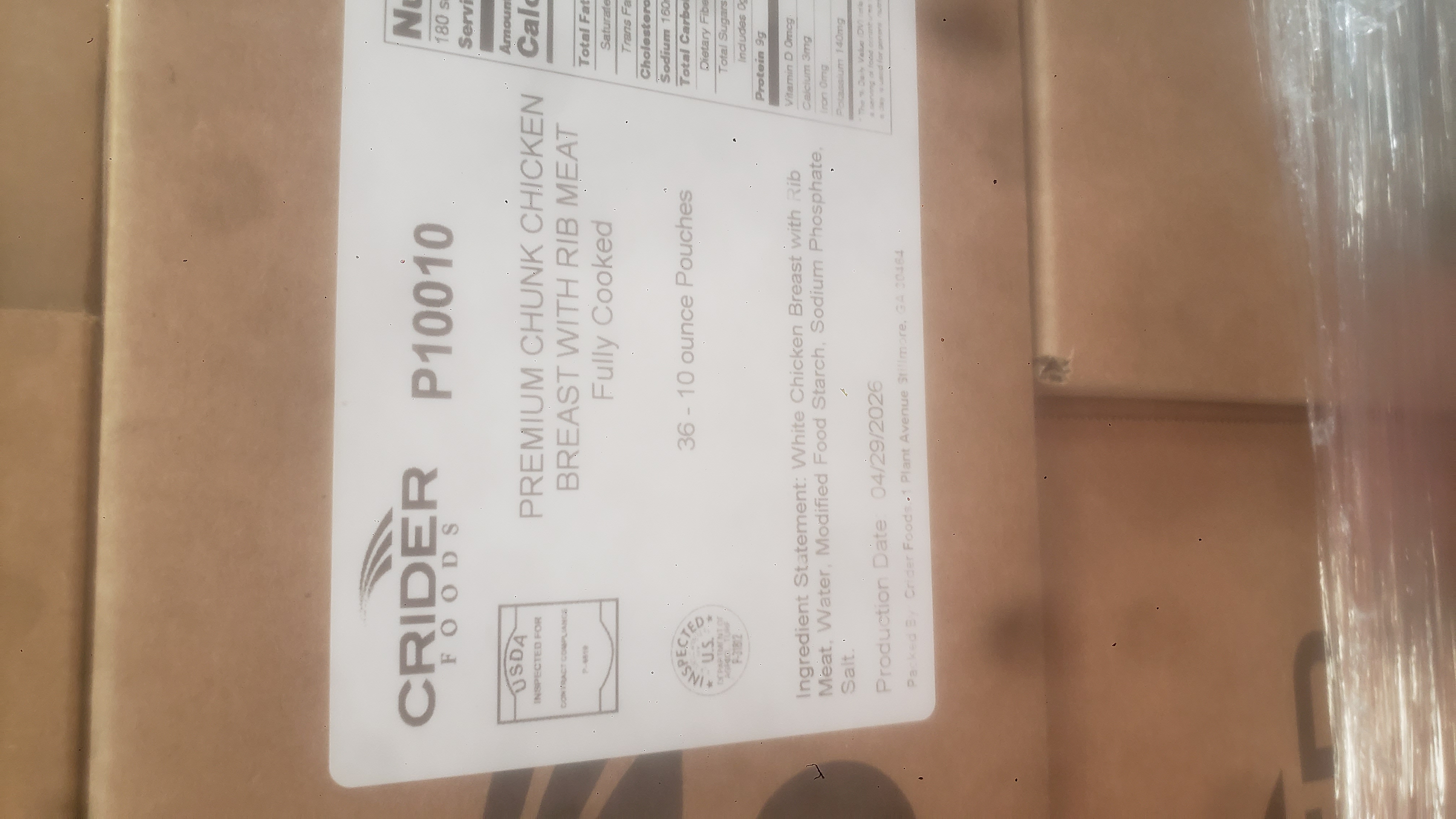 Label for fully cooked premium chunk chicken breast with rib meat pouches on a cardboard box.