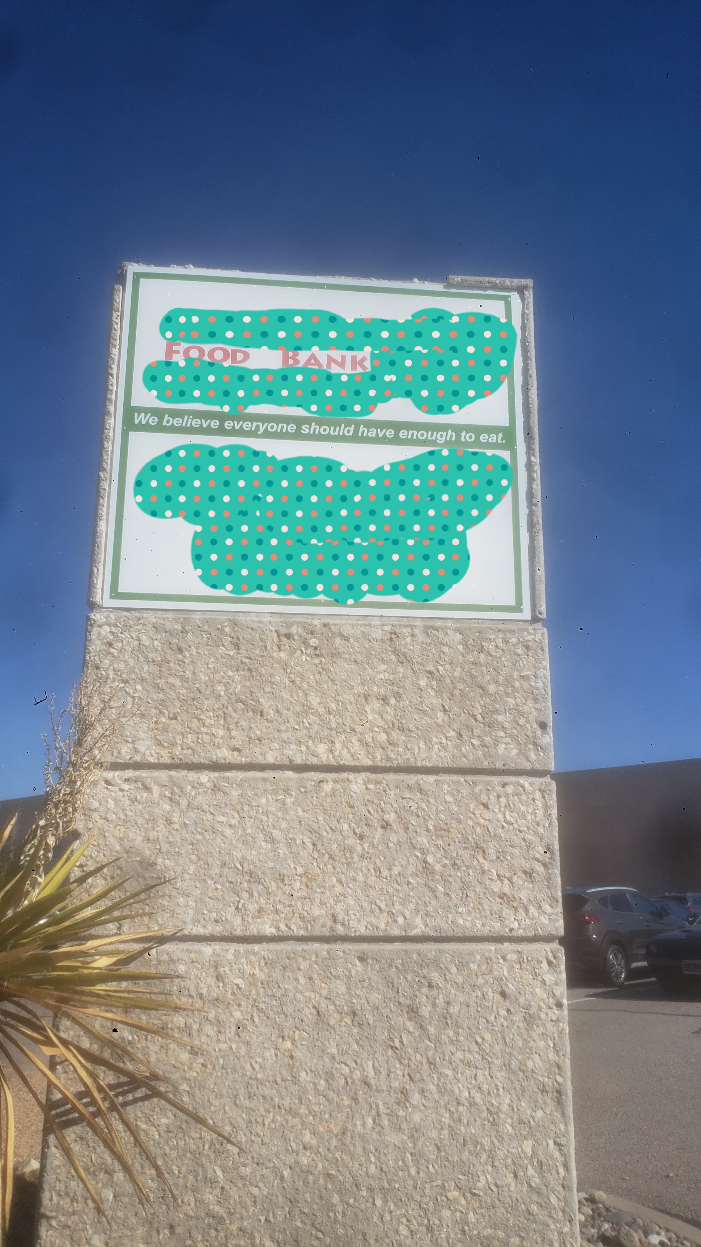 Food bank sign with the slogan we believe everyone should have enough to eat.