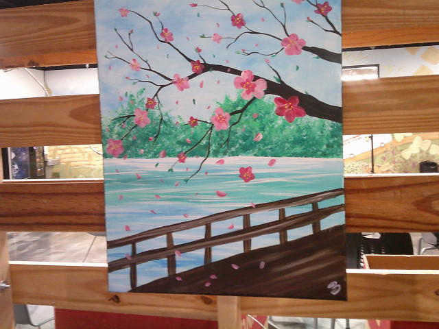 A painting of a cherry blossom tree branch overhanging a dock and a body of water.